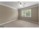 Bedroom with window view, carpeting and ceiling fan offering comfortable living space at 607 Lees Mill Rd, Fayetteville, GA 30214
