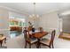 Well-lit dining room with wood table, with open access to kitchen and nearby living areas at 607 Lees Mill Rd, Fayetteville, GA 30214