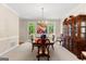 Traditional dining room with wood table, decorative china cabinet, and views to outdoors at 607 Lees Mill Rd, Fayetteville, GA 30214