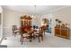 Formal dining room featuring a wood table, china cabinet, and access to the kitchen at 607 Lees Mill Rd, Fayetteville, GA 30214