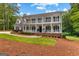 Charming home boasting a double porch, black shutters, and lush landscaping at 607 Lees Mill Rd, Fayetteville, GA 30214