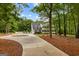 Charming home with a long driveway, featuring a spacious yard and mature trees at 607 Lees Mill Rd, Fayetteville, GA 30214