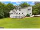 View of the home showcasing the backyard, deck, and manicured lawn at 607 Lees Mill Rd, Fayetteville, GA 30214