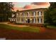 Stately two-story home with a covered porch on both levels, offering curb appeal and outdoor living spaces at 607 Lees Mill Rd, Fayetteville, GA 30214