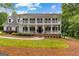 Inviting two-story home with a double-decker porch and well-manicured lawn at 607 Lees Mill Rd, Fayetteville, GA 30214