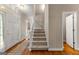 Elegant foyer featuring hardwood floors, staircase, and natural light from the front door at 607 Lees Mill Rd, Fayetteville, GA 30214