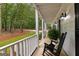 Inviting front porch with classic rocking chairs and views of the landscaped yard at 607 Lees Mill Rd, Fayetteville, GA 30214