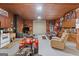 Spacious garage area featuring an ATV, multiple storage cabinets, roll up door and ample space for various activities at 607 Lees Mill Rd, Fayetteville, GA 30214