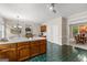Spacious kitchen with an island, unique tile flooring, and view to a dining area and the living room at 607 Lees Mill Rd, Fayetteville, GA 30214