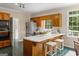 Classic kitchen featuring a central island with breakfast bar, wood cabinets, and stainless steel appliances at 607 Lees Mill Rd, Fayetteville, GA 30214