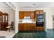 Kitchen with wooden cabinets, built-in appliances, and green tile flooring at 607 Lees Mill Rd, Fayetteville, GA 30214