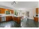 Large kitchen boasts an island, tile flooring, stainless steel appliances, and bright natural light at 607 Lees Mill Rd, Fayetteville, GA 30214