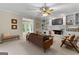 Bright living room with a fireplace, built-in shelving, and views of the backyard at 607 Lees Mill Rd, Fayetteville, GA 30214