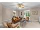 Bright living room with an inviting leather sofa and windows that showcase the outdoor greenery at 607 Lees Mill Rd, Fayetteville, GA 30214