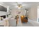 Inviting living room with built-in shelves, fireplace, ceiling fan, and natural light at 607 Lees Mill Rd, Fayetteville, GA 30214