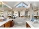 Spacious main bathroom with a vaulted ceiling, double vanity, and soaking tub at 607 Lees Mill Rd, Fayetteville, GA 30214
