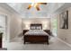 Inviting main bedroom with tray ceiling, carpeted floor, and window views at 607 Lees Mill Rd, Fayetteville, GA 30214
