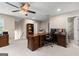 Home office featuring a ceiling fan, custom wood built-ins, desk, and a rolling office chair at 607 Lees Mill Rd, Fayetteville, GA 30214