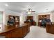 Spacious office features an elegant ceiling fan, carpeted floors, and built-in wood desks and bookshelves at 607 Lees Mill Rd, Fayetteville, GA 30214