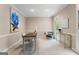 Bright home office bathed in light, featuring carpet flooring, a desk and cozy seating area at 607 Lees Mill Rd, Fayetteville, GA 30214