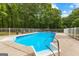 Sparkling in-ground pool with safety fence and patio seating area, perfect for relaxation at 607 Lees Mill Rd, Fayetteville, GA 30214