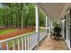 Inviting porch featuring rocking chairs and serene views of the wooded surroundings at 607 Lees Mill Rd, Fayetteville, GA 30214