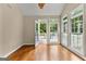 Sunroom with wood floors, many windows, and a door leading to the backyard deck at 607 Lees Mill Rd, Fayetteville, GA 30214
