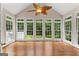 Bright sunroom with hardwood floors and large windows providing a view of the backyard at 607 Lees Mill Rd, Fayetteville, GA 30214