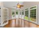 Bright sunroom with hardwood floors, floor-to-ceiling windows, and access to the backyard deck and outdoor space at 607 Lees Mill Rd, Fayetteville, GA 30214