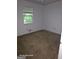 Unfurnished bedroom with carpeted floors and a window for natural light and ventilation at 115 Lakeview Dr, Stockbridge, GA 30281