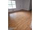Spacious living room with laminate flooring, ample natural light, and a front door at 115 Lakeview Dr, Stockbridge, GA 30281