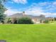 Expansive backyard with a lush green lawn and mature trees, perfect for outdoor enjoyment at 335 Canvasback Trl, Locust Grove, GA 30248