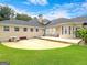 Backyard view featuring a patio, built-in seating, and neutral stucco exterior at 335 Canvasback Trl, Locust Grove, GA 30248