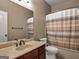 A well-lit bathroom with a classic vanity and shower-tub combo at 335 Canvasback Trl, Locust Grove, GA 30248
