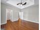 Bedroom featuring hardwood floors, tray ceiling, and two doorways at 335 Canvasback Trl, Locust Grove, GA 30248