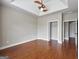 Bedroom with wood floors, tray ceiling, and walk-in closet at 335 Canvasback Trl, Locust Grove, GA 30248
