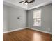 A gray bedroom with hardwood floors, tray ceiling and a large window at 335 Canvasback Trl, Locust Grove, GA 30248