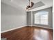 Bedroom showcasing tray ceiling, hardwood floors, and a large arched window at 335 Canvasback Trl, Locust Grove, GA 30248