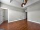 Bedroom featuring hardwood floors, ceiling fan, and two doorways at 335 Canvasback Trl, Locust Grove, GA 30248