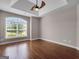 Bedroom showcasing hardwood floors, large window, and tray ceiling at 335 Canvasback Trl, Locust Grove, GA 30248