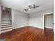 Bonus room has hardwood floors, two ceiling fans, and an adjacent staircase at 335 Canvasback Trl, Locust Grove, GA 30248
