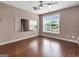 Bonus room features hardwood floors, a ceiling fan, and a large mirrored wall at 335 Canvasback Trl, Locust Grove, GA 30248