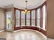 Bright dining area features many windows, neutral tile floors, and a modern light fixture at 335 Canvasback Trl, Locust Grove, GA 30248
