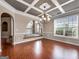 Formal dining room features wood floors, coffered ceilings and large window at 335 Canvasback Trl, Locust Grove, GA 30248