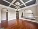 View of dining room with wood floors, coffered ceilings and arched doorways at 335 Canvasback Trl, Locust Grove, GA 30248