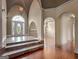 Grand entryway with stone floors, arched doorways, and elegant chandeliers at 335 Canvasback Trl, Locust Grove, GA 30248