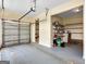 Garage with garage door and shelving at 335 Canvasback Trl, Locust Grove, GA 30248