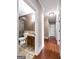 Hallway leading to bathroom with stone shower and wood floors at 335 Canvasback Trl, Locust Grove, GA 30248