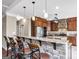 Open concept kitchen features a stone breakfast bar and stainless steel appliances at 335 Canvasback Trl, Locust Grove, GA 30248