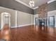 Bright living room featuring hardwood floors, a stone fireplace, and ample open space at 335 Canvasback Trl, Locust Grove, GA 30248